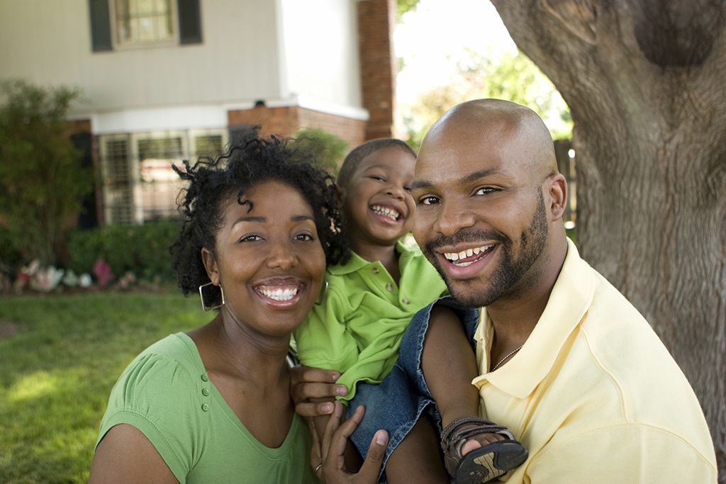 Couple holding child outside
