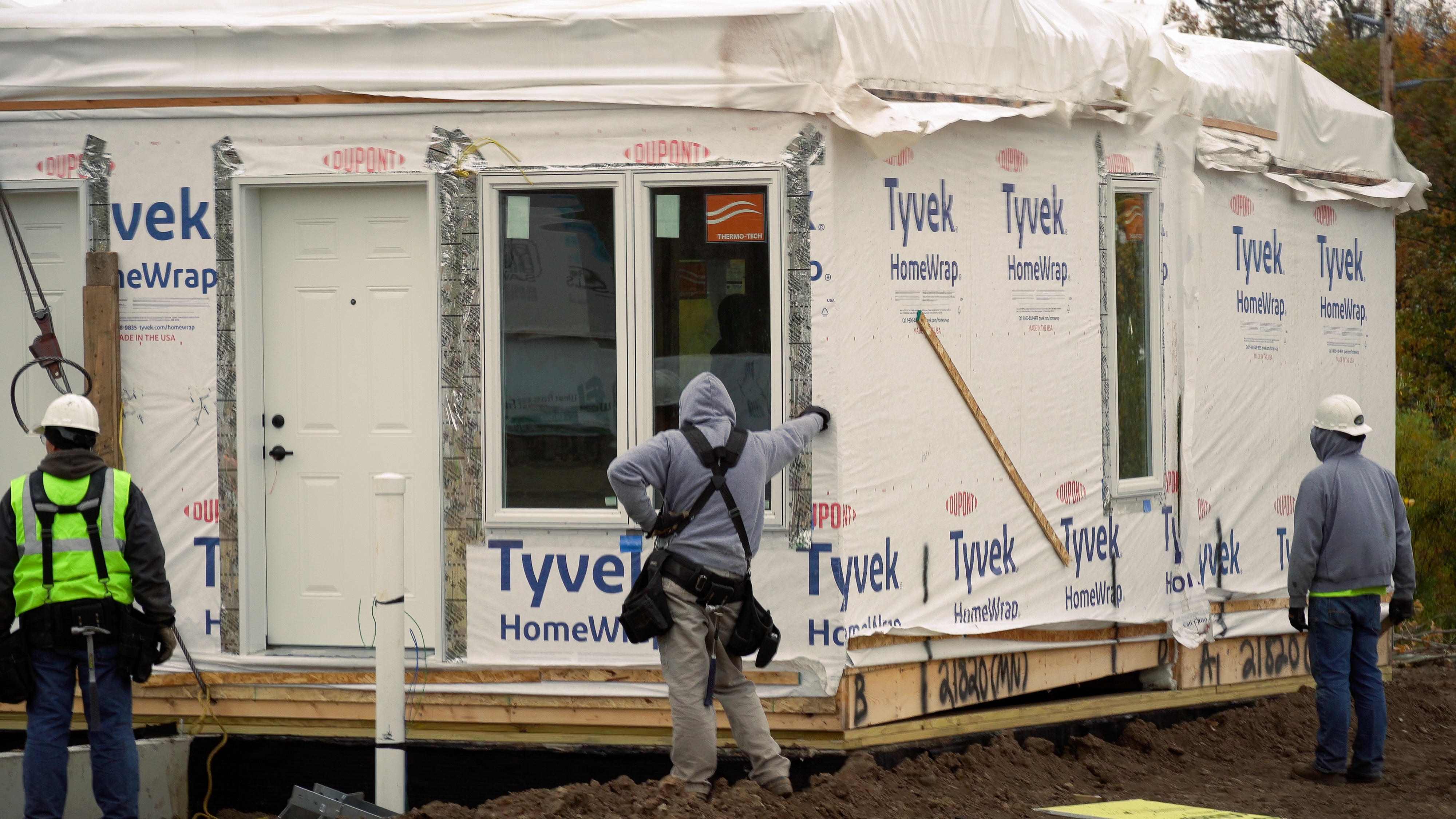 Men around modular housing under constrcution.jpg