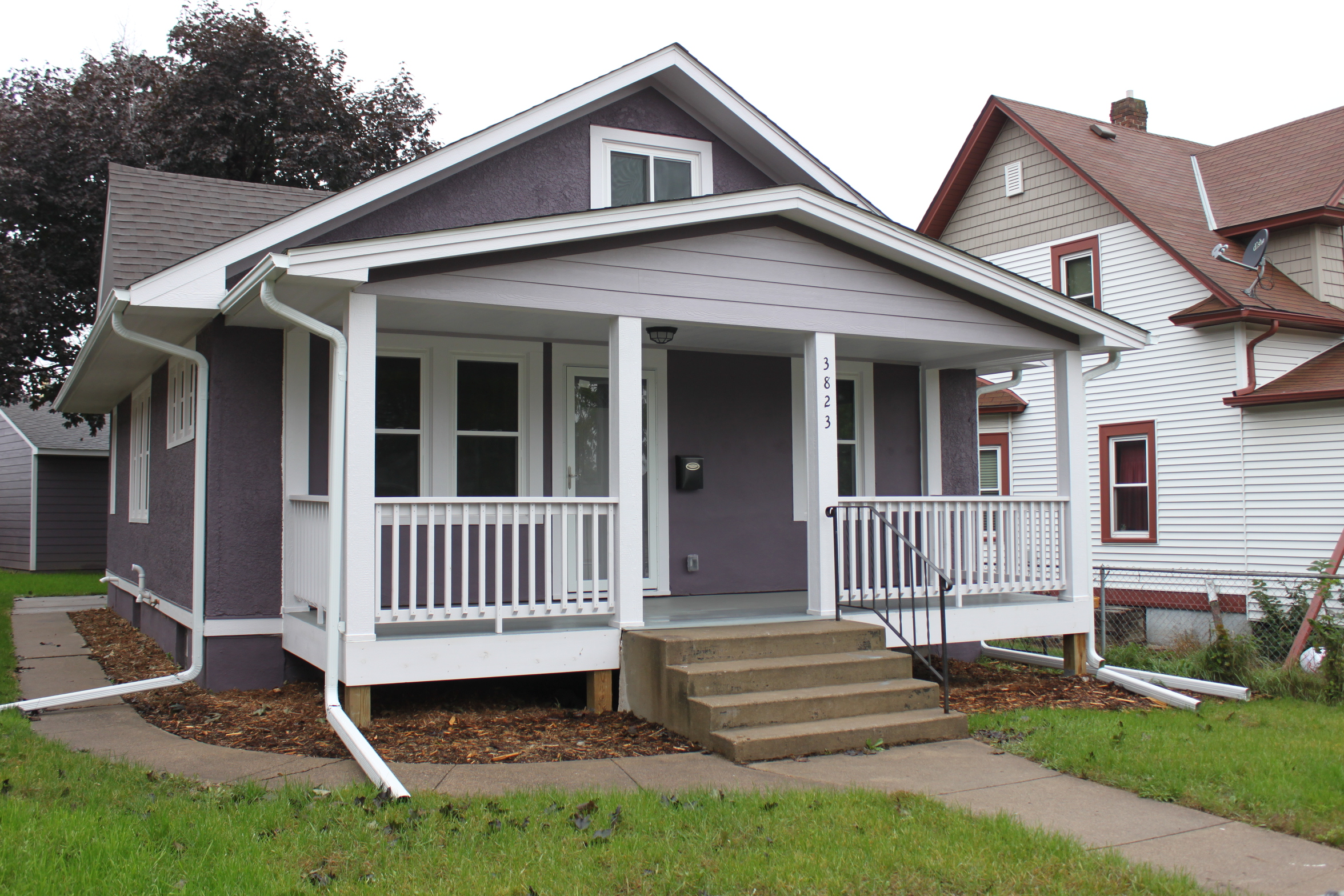 Single-family gray house and white porch