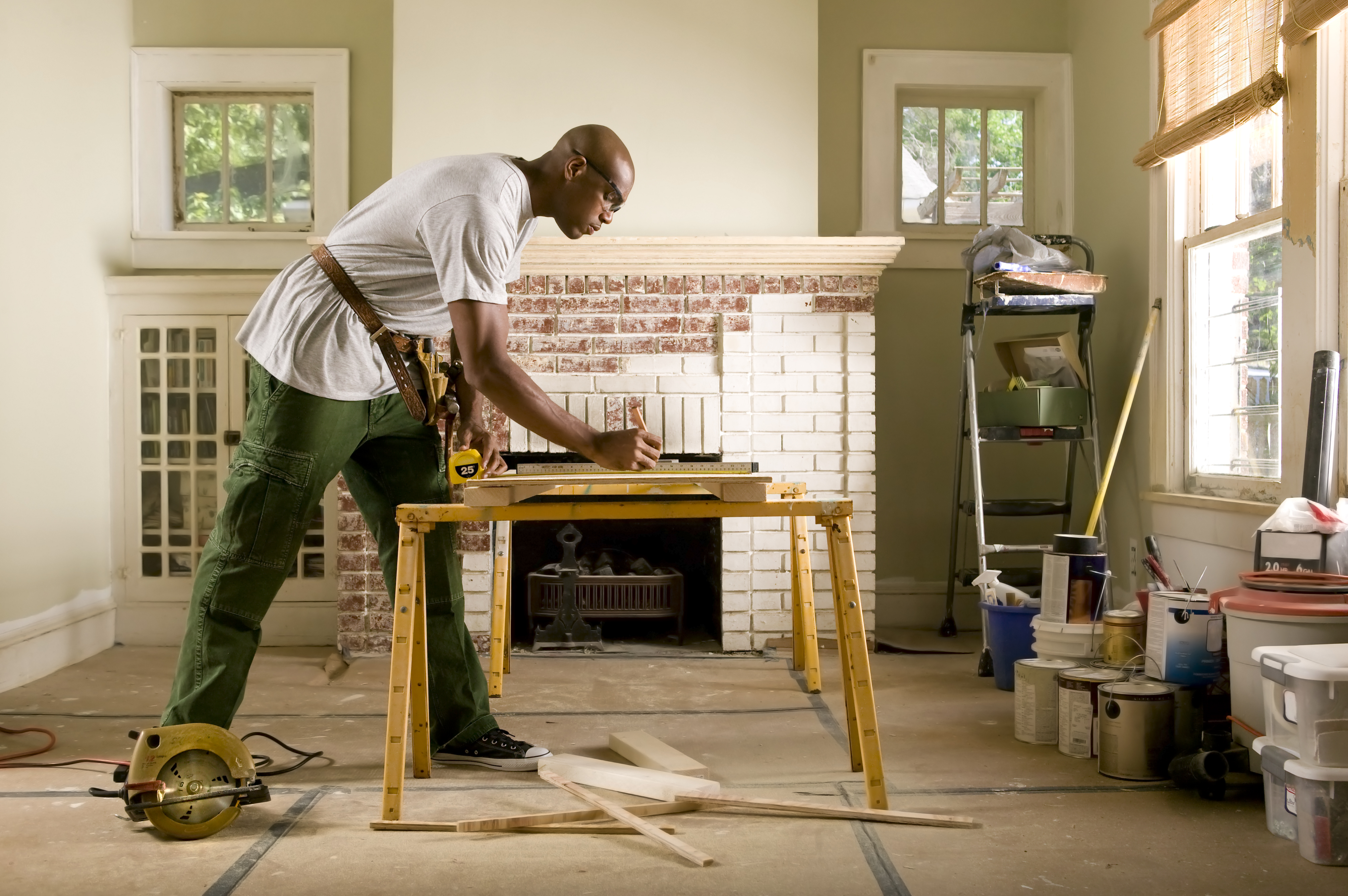 black young male renovating a room