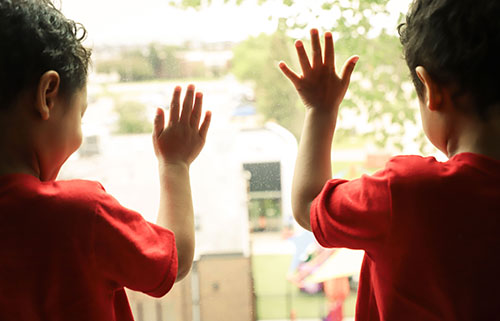 Children hands on window