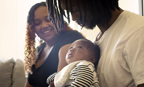 Man holding baby with woman