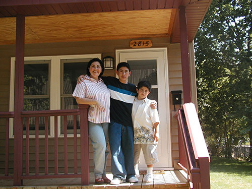 Woman and two kids on front steps