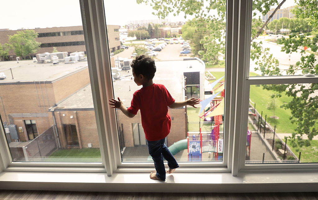 Child_standing_in_window