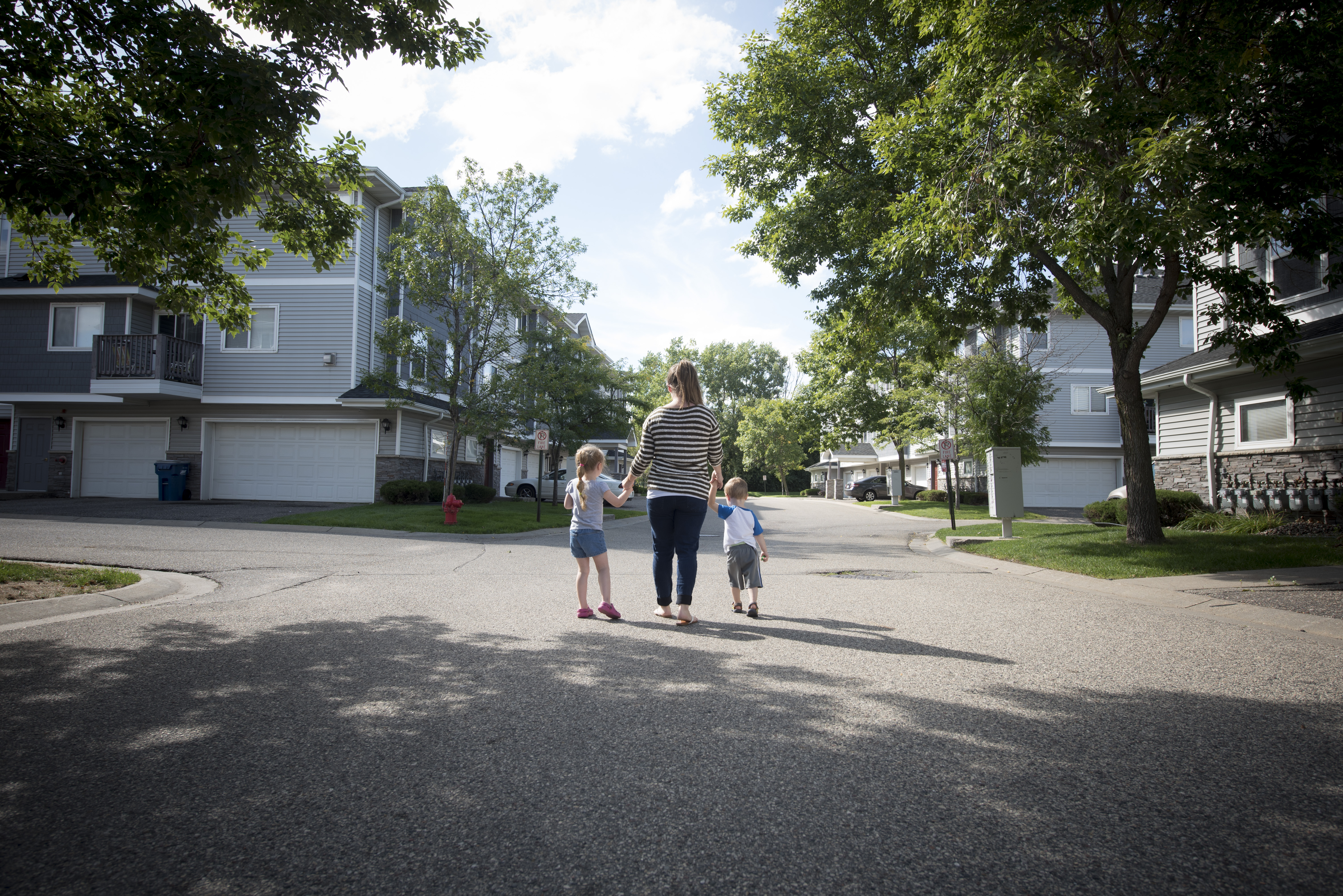 Woman_and_two_kids_walking_down_street
